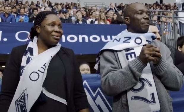 Victoria Davies with her husband in the field to support their son Alphonso Davies.